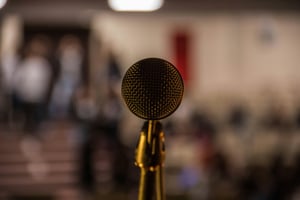 Microphone stood up facing the audience on a stage