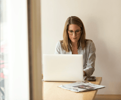 Female executive working on her laptop at home office