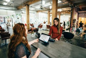 women paying for a service at the checkout table