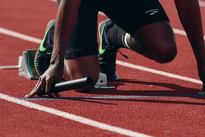 Track runner on a knee ready to start the race